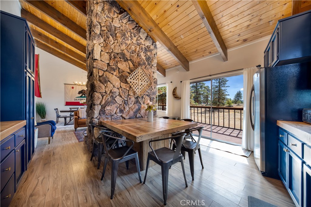39651 Flicker Road Fawnskin, CA 92333 - Photo 10 of 58 a view of a dining room with furniture window and wooden floor