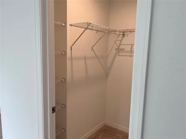 an empty room with closet and mirror