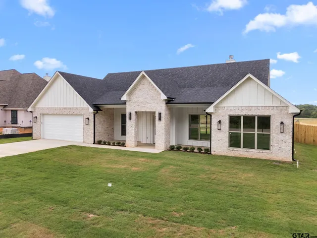 a view of a house with a garden and yard