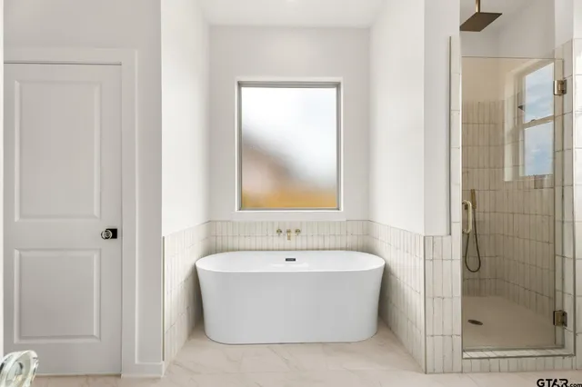 a white bath tub sitting next to a white sink