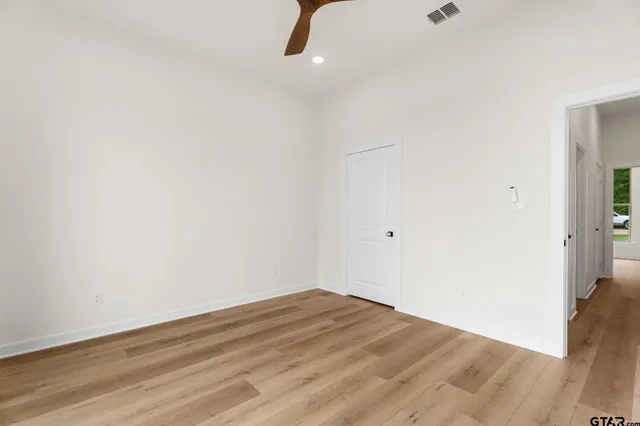 a view of a room with wooden floor