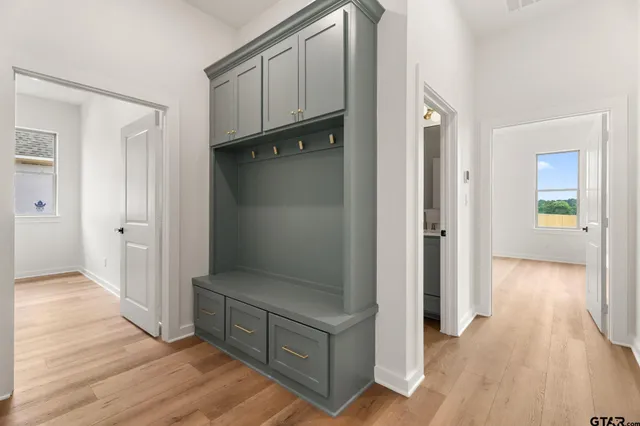 a view of a hallway with wooden floor and staircase