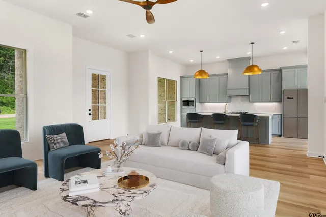 a living room with furniture and kitchen view