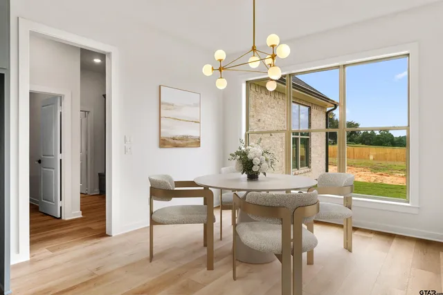 a view of a dining room with furniture wooden floor and chandelier