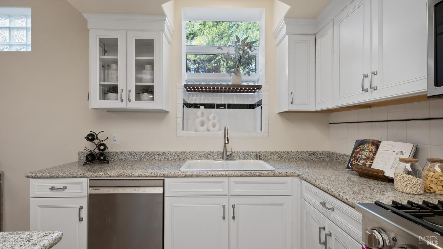 17867 Deer Hill Road Hidden Valley Lake, CA 95467 - Photo 19 of 53 a kitchen with stainless steel appliances granite countertop white cabinets and a window