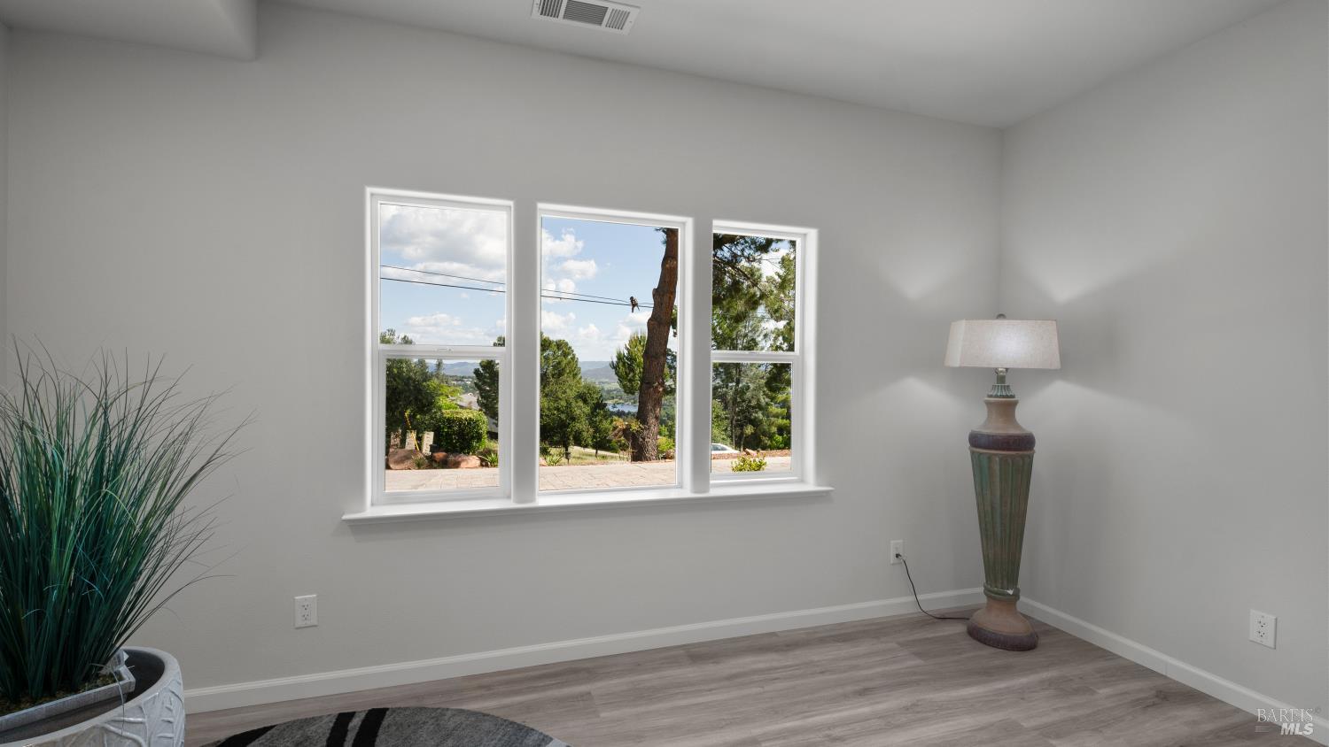 17867 Deer Hill Road Hidden Valley Lake, CA 95467 - Photo 27 of 53 a view of empty room with window and wooden floor