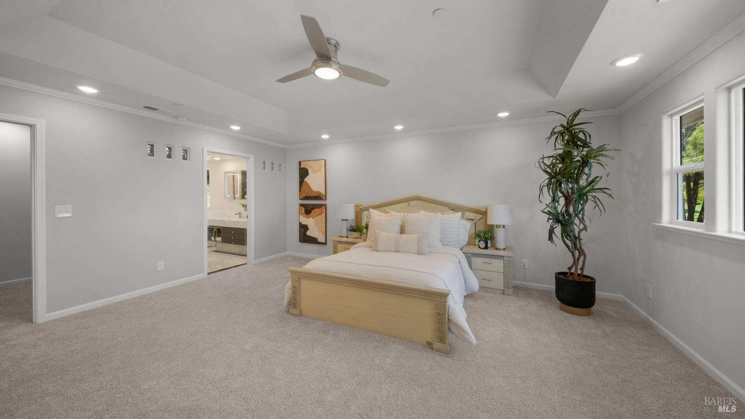 17867 Deer Hill Road Hidden Valley Lake, CA 95467 - Photo 40 of 53 a spacious bedroom with a bed and a chandelier