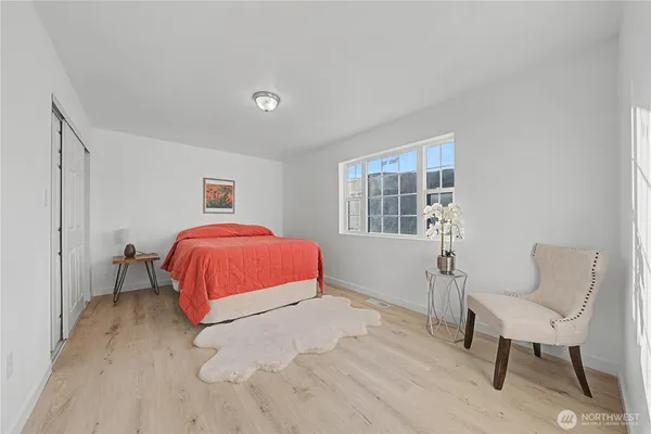 a spacious bedroom with a large bed and a large window