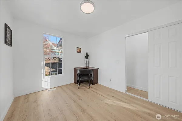 a view of a workspace with furniture and a window
