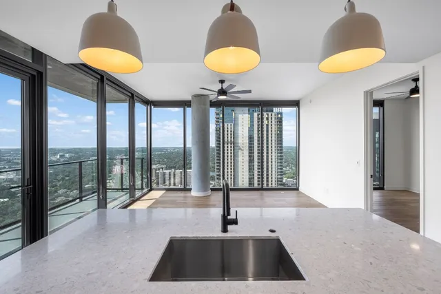 a kitchen with a sink and a lamp