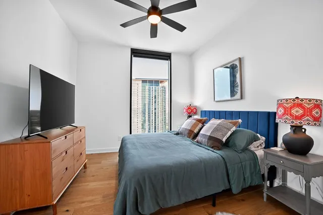 a bedroom with a bed and a flat screen tv