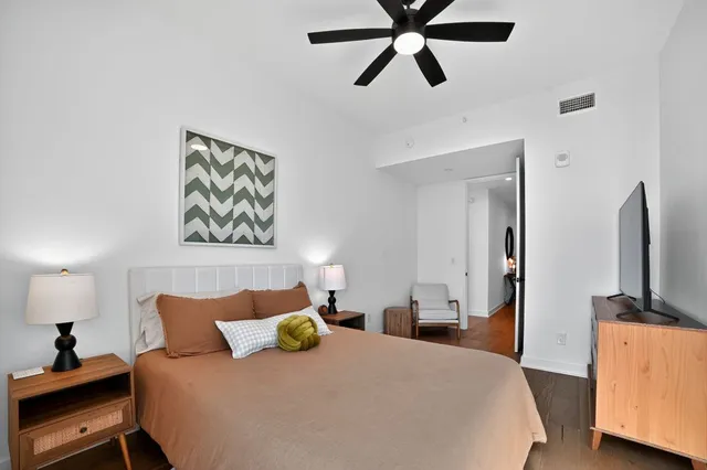 a bedroom with a bed and a flat screen tv