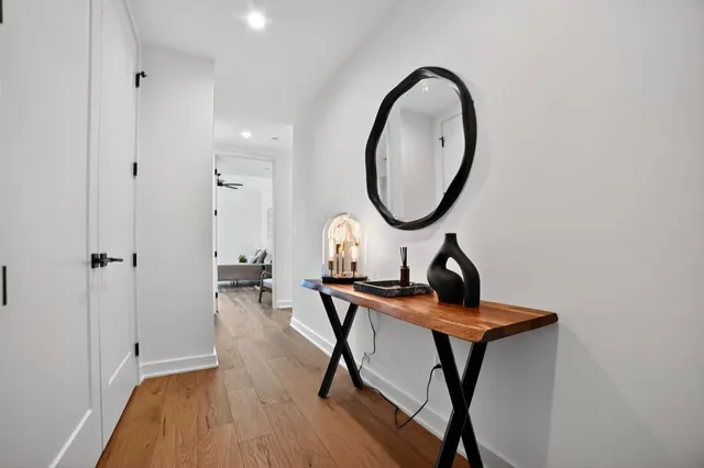 a living room with furniture and a mirror