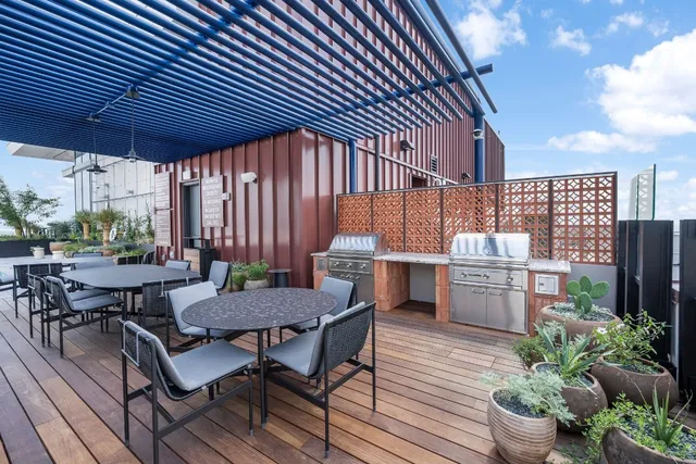 a patio with glass top table and chairs