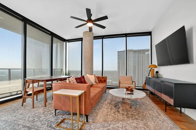 a living room with furniture and a flat screen tv
