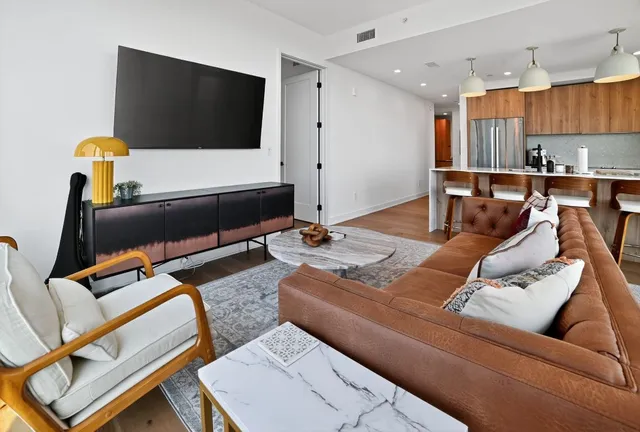 a living room with furniture and a flat screen tv