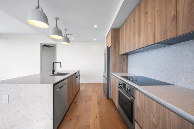 a kitchen with stainless steel appliances granite countertop a sink and a stove