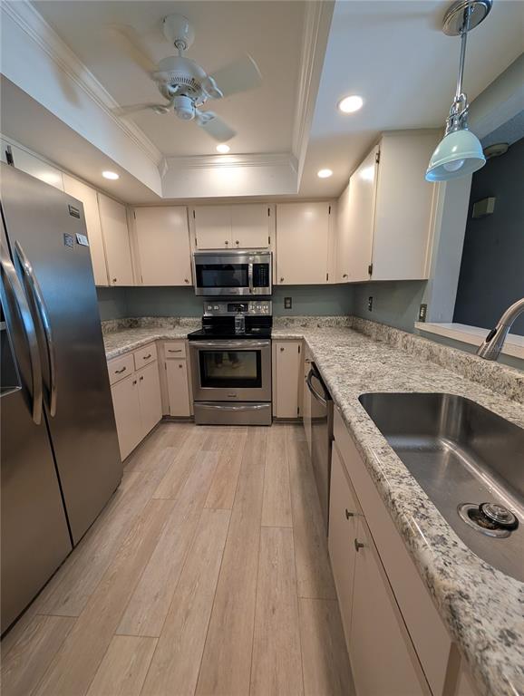 8161 Braddock Circle, Unit 1 Port Richey, FL 34668 - Photo 8 of 27 a kitchen with stainless steel appliances granite countertop a sink a stove and a refrigerator