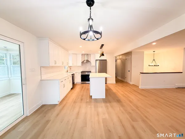 a view of a kitchen with wooden floor