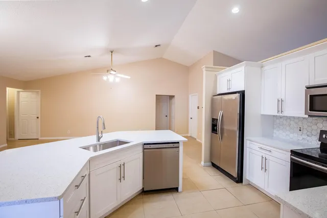 a kitchen with a sink and refrigerator