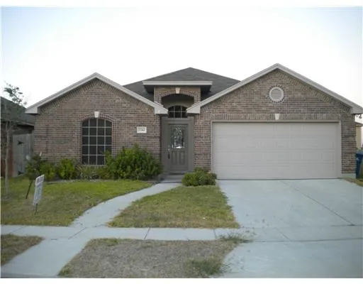 a front view of a house with yard and garage