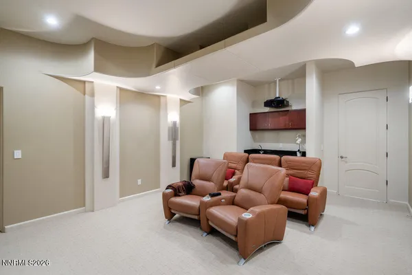 a living room with furniture and kitchen view