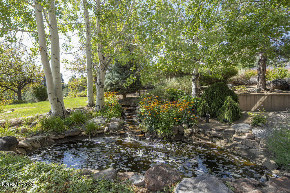 6065 Lake Geneva Drive Reno, NV 89511 - Photo 16 of 101 a view of a garden with large trees