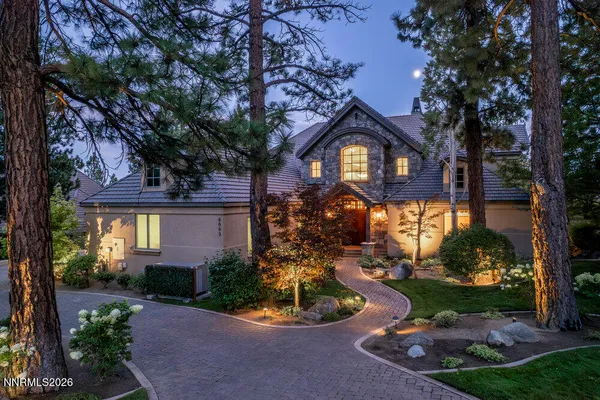 a view of a house with sitting area and garden