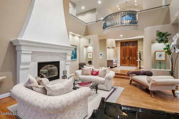 a living room with furniture fireplace and a large window