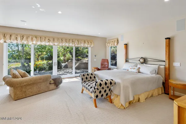 a kitchen with stainless steel appliances granite countertop a stove top oven a sink a dining table and chairs