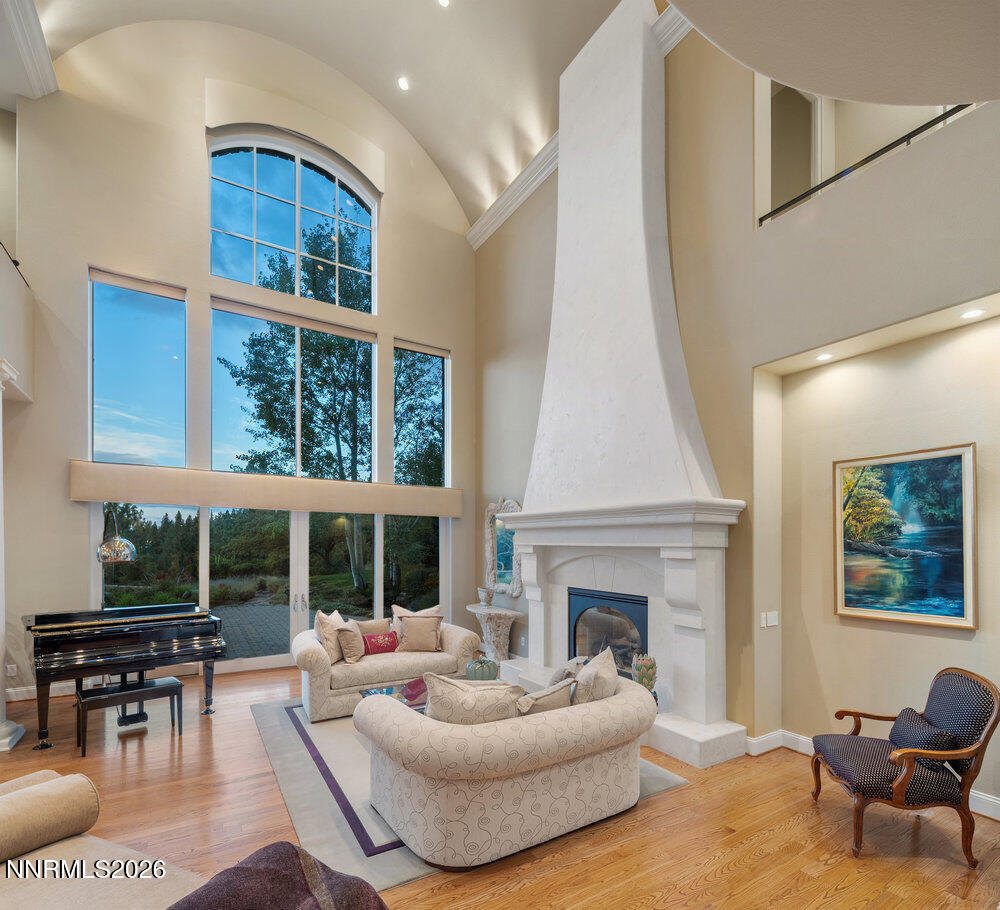 6065 Lake Geneva Drive Reno, NV 89511 - Photo 3 of 101 a living room with furniture a fireplace and a large window