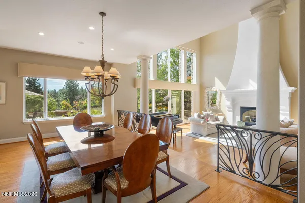 a view of swimming pool with lawn chairs under an umbrella