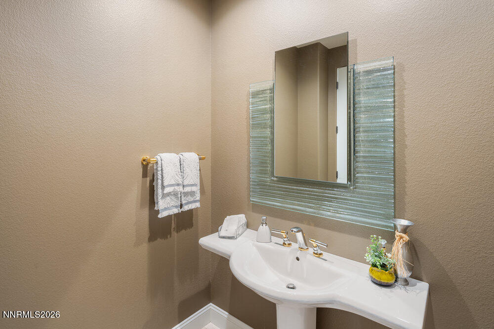 6065 Lake Geneva Drive Reno, NV 89511 - Photo 61 of 101 a bathroom with a sink and a mirror