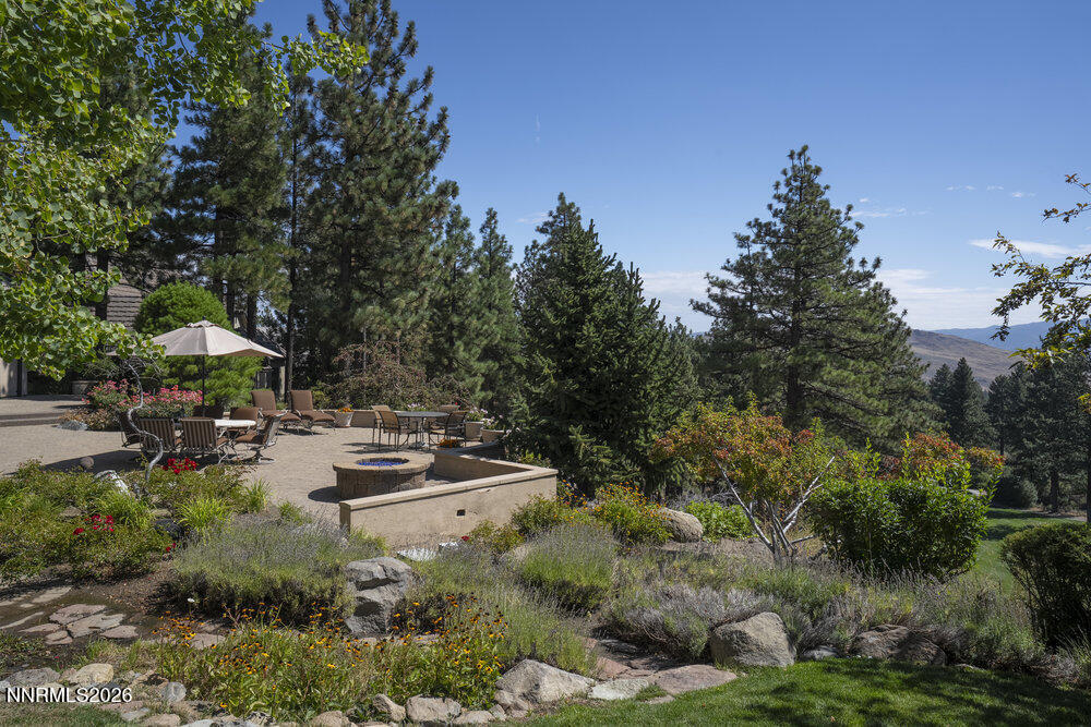 6065 Lake Geneva Drive Reno, NV 89511 - Photo 97 of 101 a view of swimming pool with lawn chairs under an umbrella