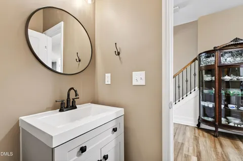a bathroom with a sink a mirror and a shower
