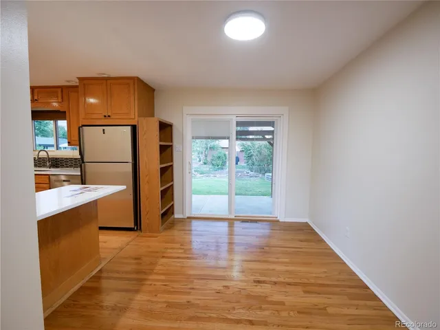 a view of a kitchen with a sink and a refrigerator