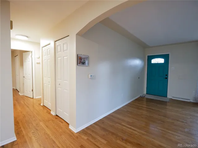 a view of hallway with wooden floor