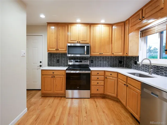 a kitchen with stainless steel appliances granite countertop a stove a sink and a granite counter tops