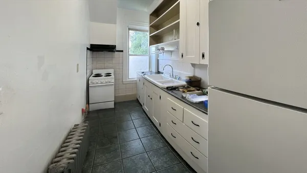 a kitchen with stainless steel appliances a refrigerator and a stove
