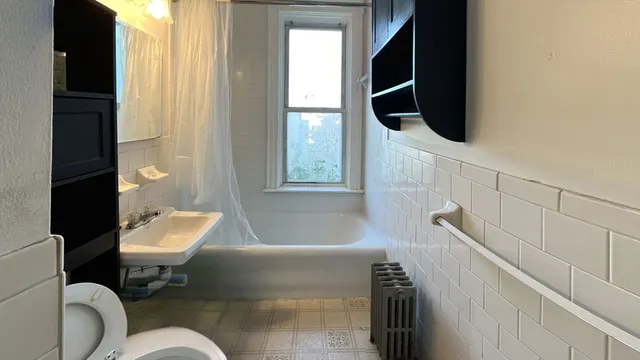 a bathroom with a toilet a sink and bathtub