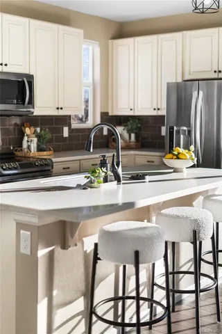 a kitchen with stainless steel appliances granite countertop a stove a sink dishwasher and cabinets