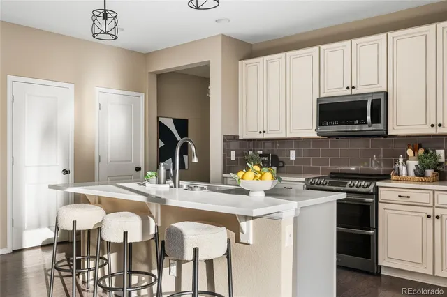 a kitchen with a sink stove and white cabinets