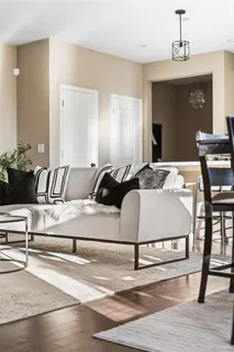 a spacious bedroom with a bed and wooden floor