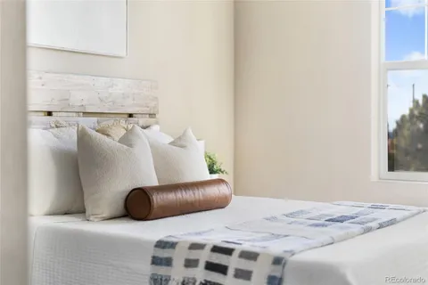 a bedroom with a bed and a couch