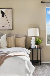 a bedroom with a bed and a painting on the wall