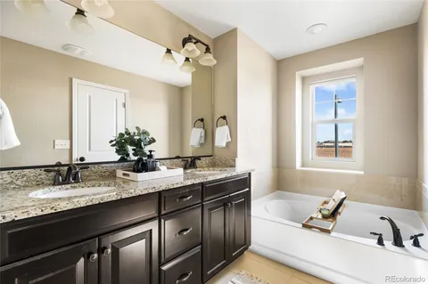 a bathroom with a sink double vanity granite and a mirror