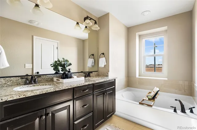 a bathroom with a sink double vanity granite and a mirror