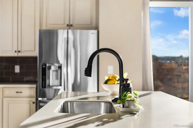 a kitchen with a sink and a refrigerator