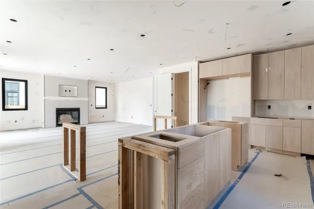a view of a kitchen with kitchen island a sink stainless steel appliances and cabinets