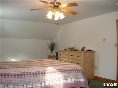 500 Point Phillips Road Bath, PA 18014 - Photo 20 of 31 a bedroom with a bed and a chandelier